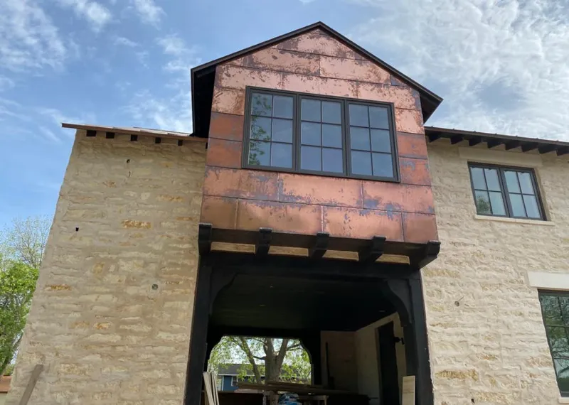 Copper metal panel facade on a stone building for Skylight Installation in Kinross